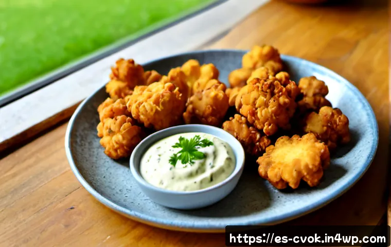 Home 17 대체 단백질 요리법으로 만드는 바삭한 튀김 - Photorealistic close-up of golden crispy fried cauliflower bites made with plant-based protein batte...